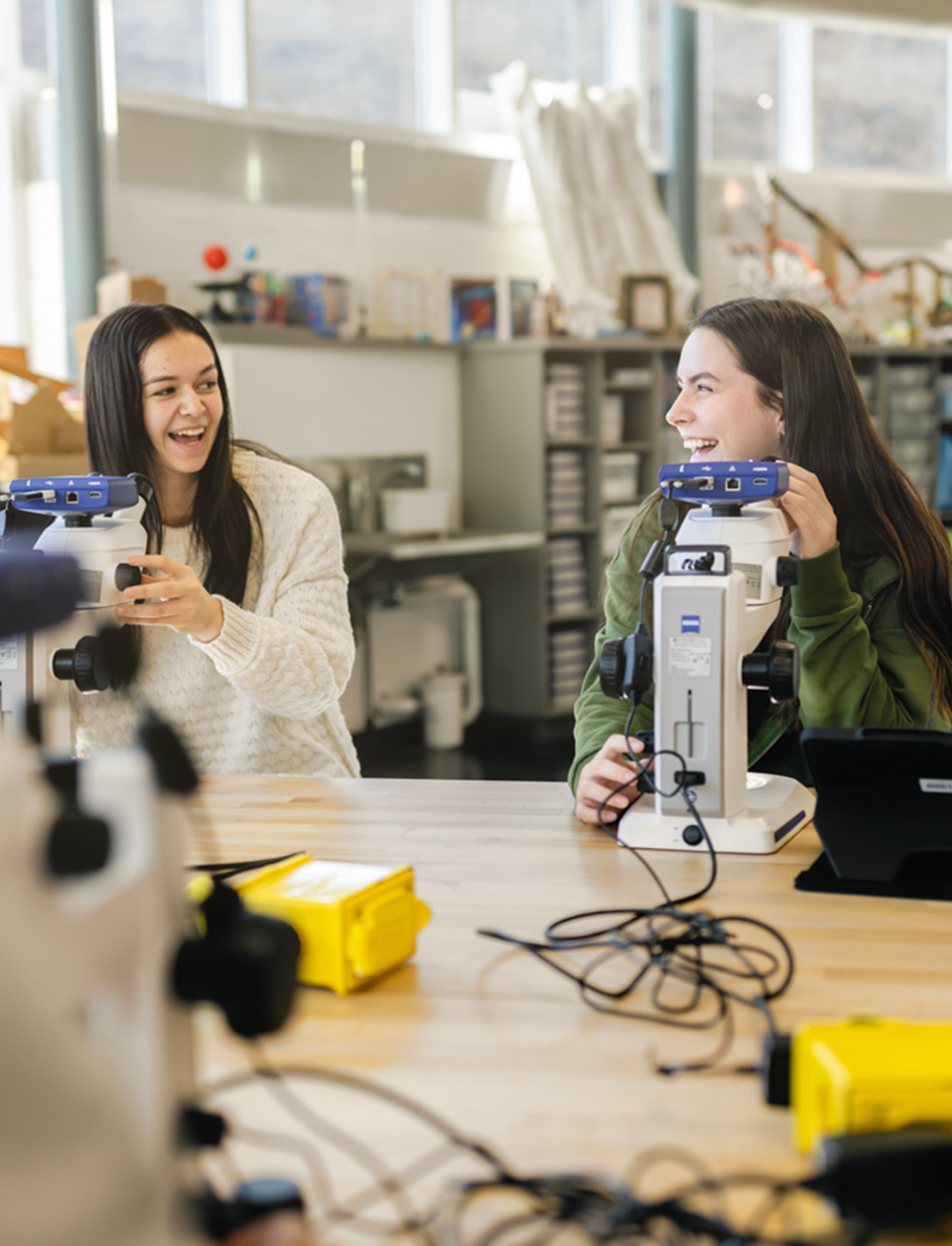 Two female students working in a science classroom